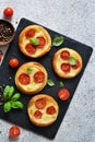 Mini pie with tomatoes and cheese. Quiche with vegetables and sauce top view