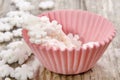 Mini pink cupcake case with white sugar flakes