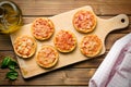 Mini pizza on cutting board