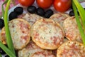 Mini pizza with tomatoes, green onions and olives