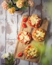 Mini pizza on wooden board. Top view from above