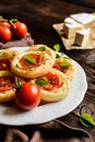 Mini pizzas with Camembert and tomato Royalty Free Stock Photo