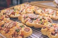 Mini pizzas with cheese, tomato, green beans, corn and sausages in the shoppin mall, small italian bakery. Tropical Royalty Free Stock Photo