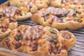 Mini pizzas with cheese, tomato, green beans, corn and sausages in the shoppin mall, small italian bakery. Tropical Royalty Free Stock Photo