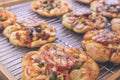 Mini pizzas with cheese, tomato, green beans, corn and sausages in the shoppin mall, small italian bakery. Tropical Royalty Free Stock Photo