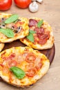 Mini pizzas on a cutting board and ingredients Royalty Free Stock Photo