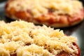 Mini pizzas or small pellets covered with cheese Royalty Free Stock Photo