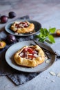 Mini plum galettes with almond slices