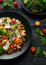 Mini potato gnocchi tricolour with tomato, spinach, Seasonal salad leaves and parmesan cheese