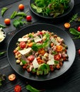 Mini potato gnocchi tricolour with tomato, spinach, Seasonal salad leaves and parmesan cheese