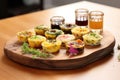 mini quiches on a serving tray, variety of flavors