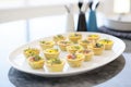 mini quiches on a white platter