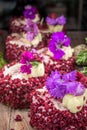 Mini raspberry cheesecake decorated with purple flowers Royalty Free Stock Photo