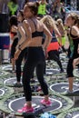 Mini Rebounder Workout - Girls doing Fitness Exercise in Class at Gym with Music and Teacher on Stage