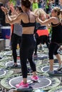 Mini Rebounder Workout - Girls doing Fitness Exercise in Class at Gym with Music and Teacher on Stage Royalty Free Stock Photo