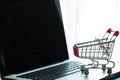 Mini Red Shopping Cart On Laptop Royalty Free Stock Photo