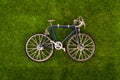 Mini retro blue toy bike on grass meadow