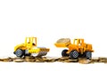 Mini Road roller machine with stack coin with pile of gold coin, isolated on white background with copy space, business finance Royalty Free Stock Photo