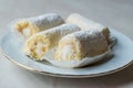 Mini Roll Cake with Vanilla Cream, Coconut and Powdered Sugar. Royalty Free Stock Photo