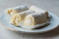 Mini Roll Cake with Vanilla Cream, Coconut and Powdered Sugar. Royalty Free Stock Photo
