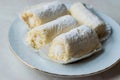 Mini Roll Cake with Vanilla Cream, Coconut and Powdered Sugar. Royalty Free Stock Photo