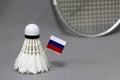 Mini Russia flag stick on the white shuttlecock on the grey background and out focus badminton racket