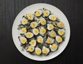 Mini sandwich with salt sprat and sliced boiled quail egg on the slice of bread. Canned fish is Estonian national food. Concept