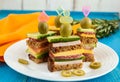 Mini sandwiches canape with fresh cucumbers, ham, cheese, olives, salami, black bread Royalty Free Stock Photo