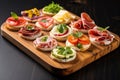 mini sandwiches with different cold cuts on an oak board Royalty Free Stock Photo