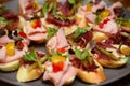 Mini sandwiches with ham and vegetables on the plate. Royalty Free Stock Photo