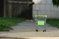 Mini shopping basket in the grass outside with a Santa hat as a concept for the new year, sales, Christmas shopping and mega promo