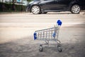 Mini shopping cart in car parking lot, Shopping concept Royalty Free Stock Photo