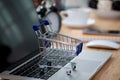 Mini shopping cart on computer laptop. Business concept. Royalty Free Stock Photo