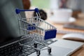 Mini shopping cart on computer laptop. Business concept. Royalty Free Stock Photo