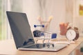 Mini shopping cart on computer laptop. Business concept. Royalty Free Stock Photo