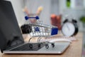 Mini shopping cart on computer laptop. Business concept. Royalty Free Stock Photo