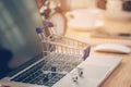 Mini shopping cart on computer laptop. Business concept. Royalty Free Stock Photo