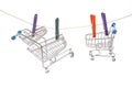 Mini shopping carts hanging on a clothesline with colorful clips in a creative display Royalty Free Stock Photo