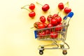 Mini shopping grocery cart full of fresh cherries Fresh berries on yellow background. Healthy summer food concept Royalty Free Stock Photo