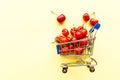 Mini shopping grocery cart full of fresh cherries Fresh berries on yellow background. Healthy summer food concept Royalty Free Stock Photo