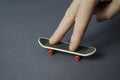 Mini skate and hand on a gray background Royalty Free Stock Photo