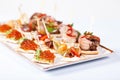 Mini snacks tapas with caviar and meat on white plate Royalty Free Stock Photo