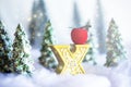 Mini snowy Christmas trees in the forest. Bokeh lights background Royalty Free Stock Photo