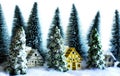 Mini snowy Christmas trees with houses in the forest. Bokeh lights background Royalty Free Stock Photo