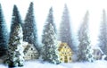 Mini snowy Christmas trees with houses in the forest. Bokeh lights background Royalty Free Stock Photo