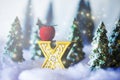 Mini snowy Christmas trees in the forest. Bokeh lights background Royalty Free Stock Photo