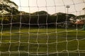 Mini-soccer Futsal field in view from behind goal net. Another goal compititor are in square view of net Royalty Free Stock Photo