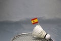 Mini Spain flag stick on the shuttlecock put on the net of badminton racket on the grey floor