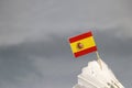 Mini Spain flag stick on the white shuttlecock on the grey background