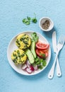 Mini spinach cheddar frittata and vegetables salad on blue background, top view. Breakfast, snack, appetizers